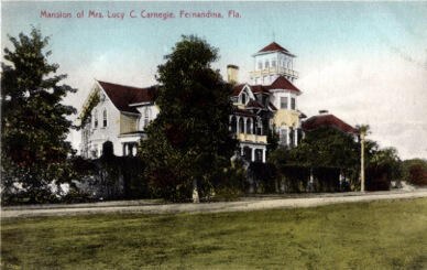 Postcard of a large Victorian mansion with a tower